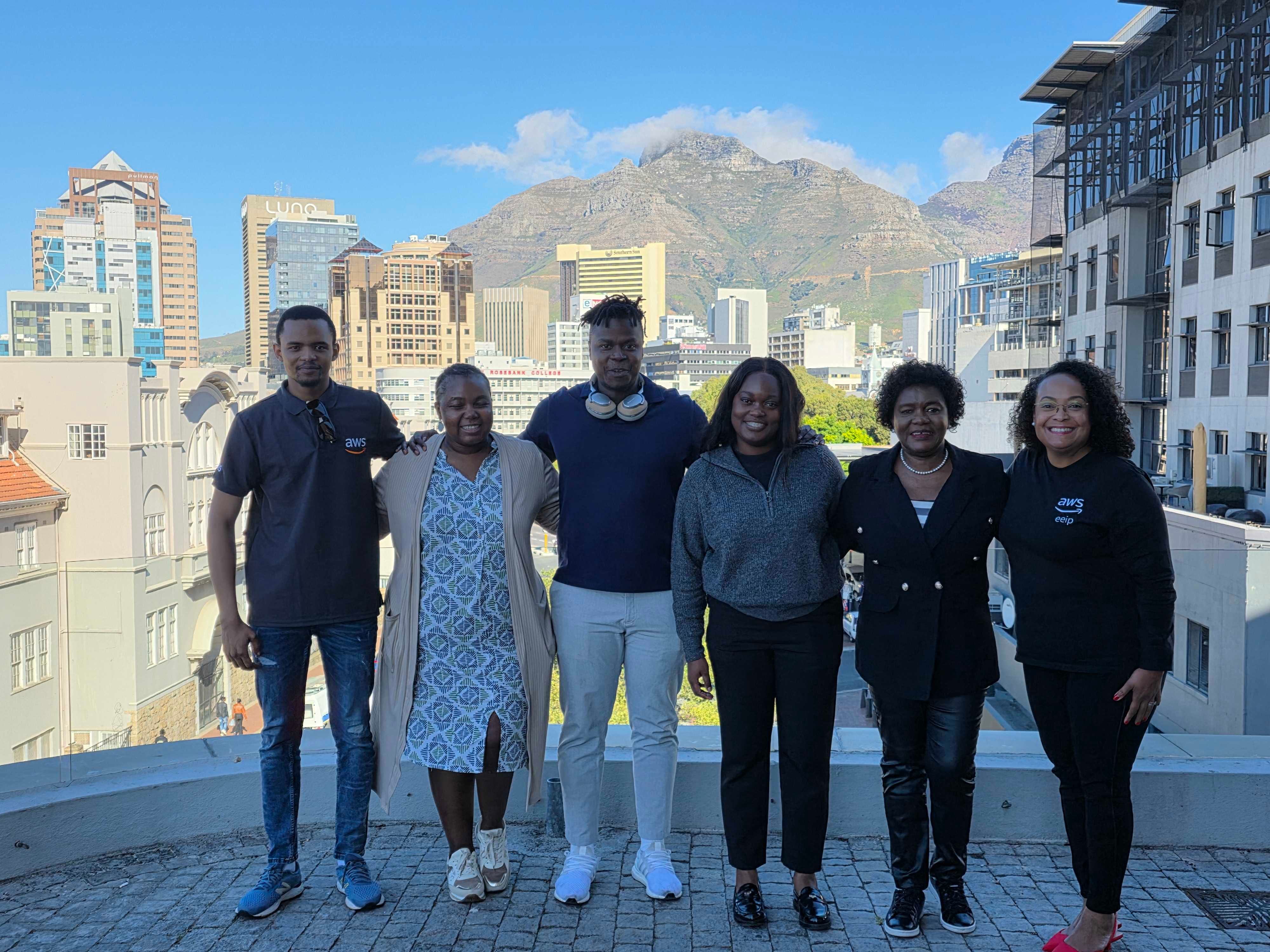 The Timbuk2 team on a rooftop above the Cape Town city bowl, Table Mountain behind them